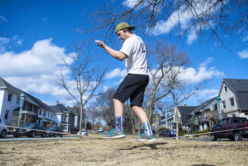 Jeff Himmelman takes advantage of the warm weather to try out his new slack line in the Hydrostone on Sunday afternoon. It’s going to be a far different story on Monday with a return to winter. A storm is expected to bring 15 centimetres of snow to parts of the province. - Ryan Taplin