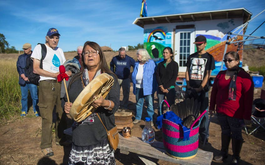 Dorene Bernard, a member of the Sipekne’katik First Nation, drums following a water ceremony along the banks of the Shubenacadie River estuary near the Treaty Truck House in Fort Ellis, Colchester County, last year. Maude Barlow, Honourary Chairperson of the Council of Canadians, joined Bernard and other opponents of the Alton Gas project at the site. - Ryan Taplin