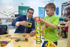 
Education Minister Zach Churchill builds a tower with pre-primary student Camren Bond at Colby Village Elementary School on Wednesday, April 10, 2019. - Ryan Taplin
