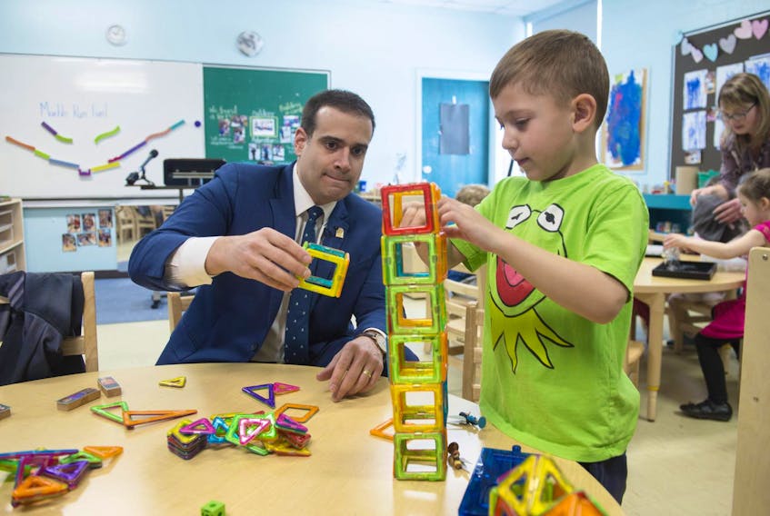 
Education Minister Zach Churchill builds a tower with pre-primary student Camren Bond at Colby Village Elementary School on Wednesday, April 10, 2019. - Ryan Taplin
