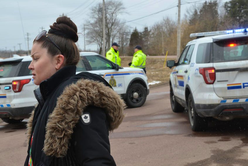 
Mi’kmaq water rights holder Michelle Paul stands in front of a police roadblock on Riverside Road near Stewiacke early Wednesday afternoon. - Francis Campbell
