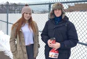 
Grade 12 students Jocie Duggan and Tom Baker stand in front of J.L. Ilsley High School’s field in Spryfield on Wednesday. - Josh Young
