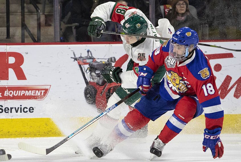 
Halifax Mooseheads’ Ostap Safin battles for the puck with Moncton Wildcats’ Jonathan Aspirot during Game 4 of their QMJHL quarter-final series on Wednesday in Moncton. - Ron Ward
