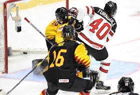 
Canada’s Blayre Turnbull scores on Germany goalie Jennifer Harss during quarter-final action at the IIHF women’s world hockey championship on Thursday. - Reuters

