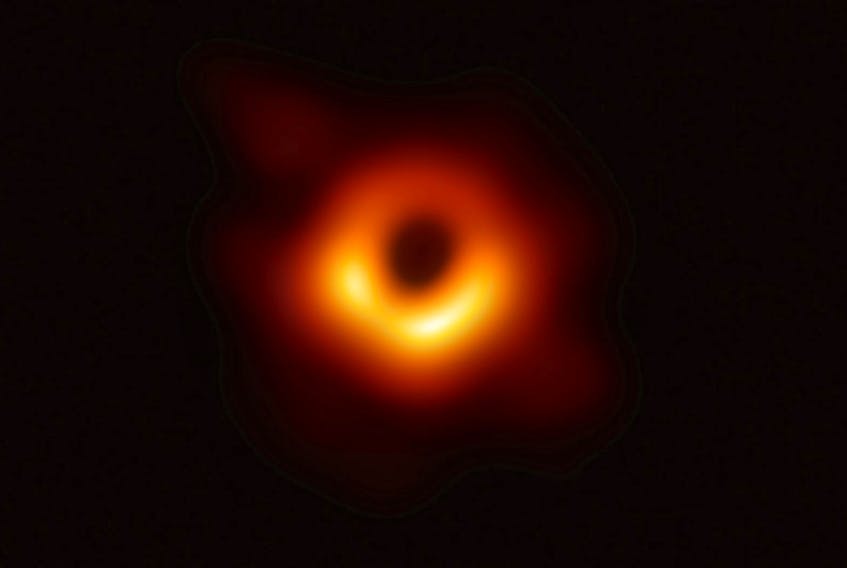 
The first ever photo of a black hole, taken using a global network of telescopes, conducted by the Event Horizon Telescope (EHT) project, to gain insight into celestial objects with gravitational fields so strong no matter or light can escape, is shown in this handout photo released April 10, 2019. - Event Horizon Telescope (EHT)/National Science Foundation/Handout via REUTERS

