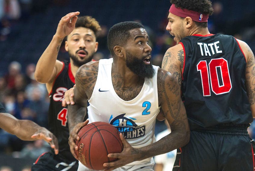 
Halifax Hurricanes shooting guard Terry Thomas drives to the hoop against Windsor Express defenders Ryan Anderson and Tyrrel Tate during an NBL Canada regular-season game at the Scotiabank Centre. - Ryan Taplin 
