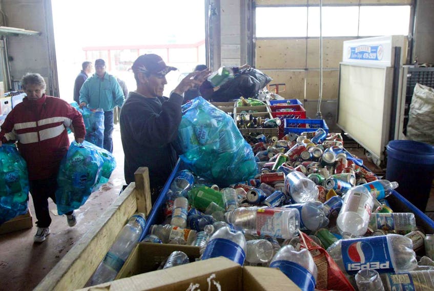 
People bring bottles and other items to a recycling depot. Bottle caps have been thrown out in the past but a recycling group has proposed using them as filters in wastewater systems and for plastic lumber. - File
