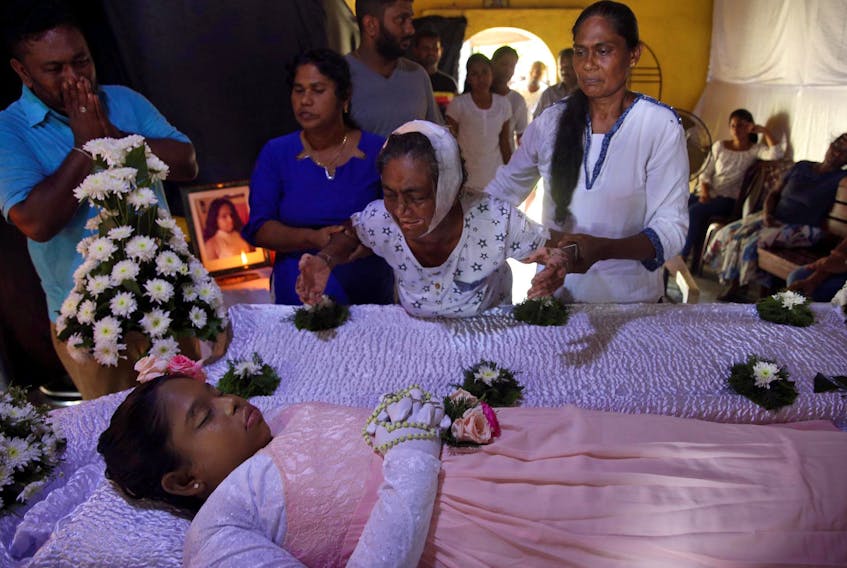 
The injured grandmother of Shaini, 13, who died as bomb blasts ripped through churches and luxury hotels on Easter, mourns at her wake, in Negombo, Sri Lanka on Monday. - Athit Perawongmetha / Reuters
