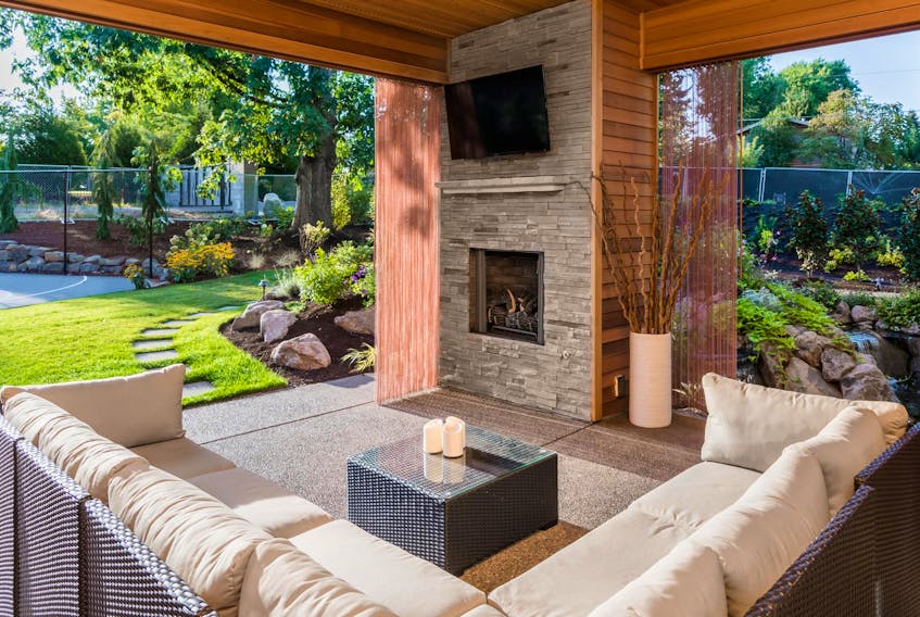 
Comfortable living and dining rooms with weatherproof furnishings, built-in bars, brick ovens and fireplaces, even outdoor movie theatres, are transforming the way people enjoy the outdoors. - Getty Images/iStockphoto
