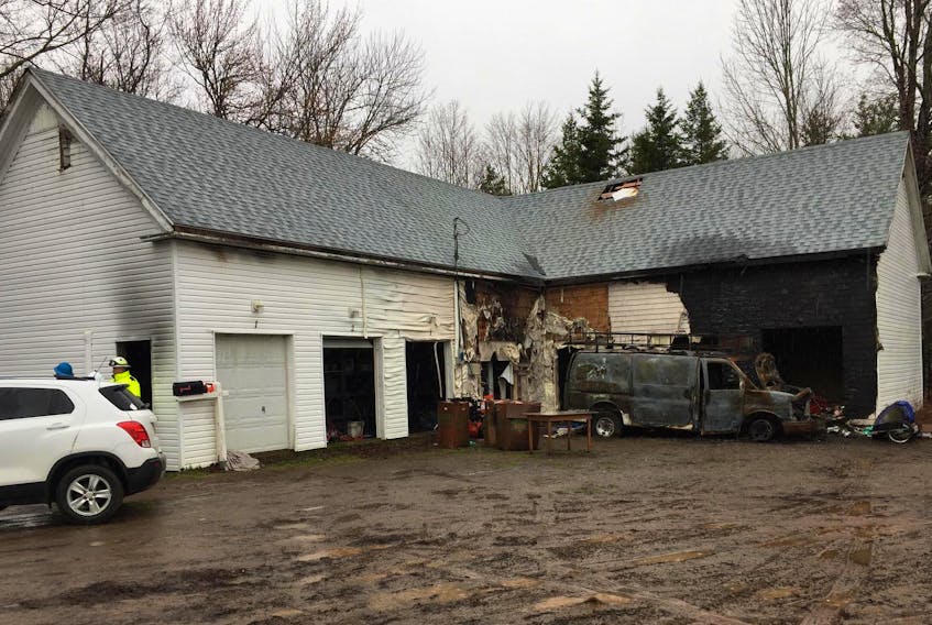 
Fire marshal’s office investigators spent a second day Tuesday, April 23, 2019 at the scene of a fire that destroyed a van and spread to a nearby business at the intersection of Prospect Road and Highway 12 in North Alton. - Ian Fairclough
