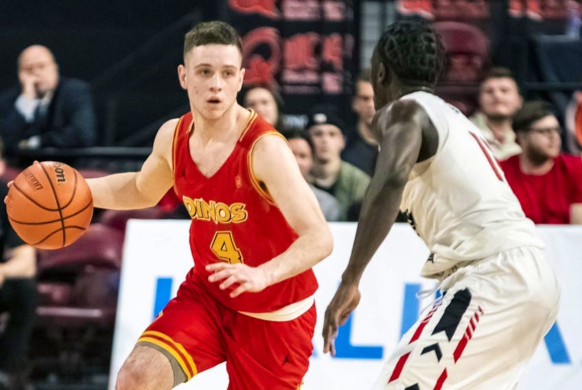 Antigonish native Andrew Milner of the Calgary Dinos makes a move on Munis Tutu of the Carleton Ravens during the 2019 U Sports Final 8 men’s basketball championships at Scotiabank Centre in Halifax.