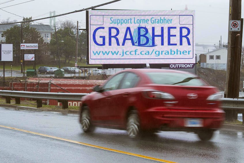 
A vehicle passes in front of a digital billboard on Barrington St. asking people to support Lorne Grabher ahead his court battle that started this week. - Ryan Taplin
