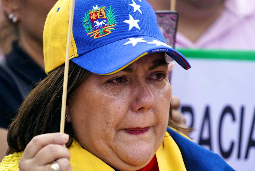 
A woman cries during a protest in support of Venezuelan opposition leader Juan Guaido at Colon Square in Madrid, Spain, May 1, 2019. - Juan Medina/ Reuters
