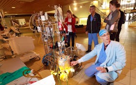 
Roger Stanzel, a cardiovascular perfusionist, demonstrates the machinery used during heart and lung surgeries in the lobby of the Infirmary Building on Summer Street. Perfusionists control the machines used to regulate blood flow and oxygen intake when surgeons render your heart or lungs temporarily inoperable. - Eric Wynne

