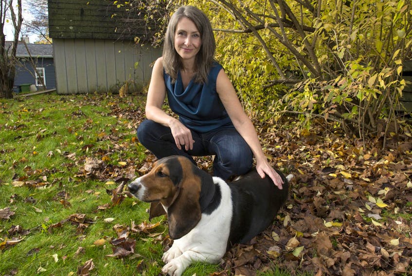 
Author Nicola Davison poses for a photo with her basset hound in the backyard of her Dartmouth home. Davison was nominated for two Atlantic Book Awards for her debut novel, In the Wake. - Ryan Taplin / File
