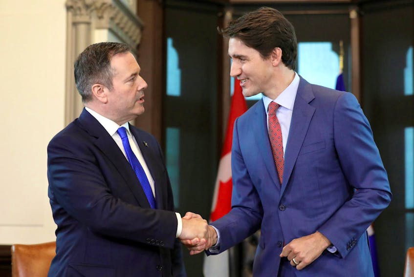 Prime Minister Justin Trudeau shakes hands with Alberta Premier Jason Kenney during a meeting in Trudeau's office on Parliament Hill on Thursday.