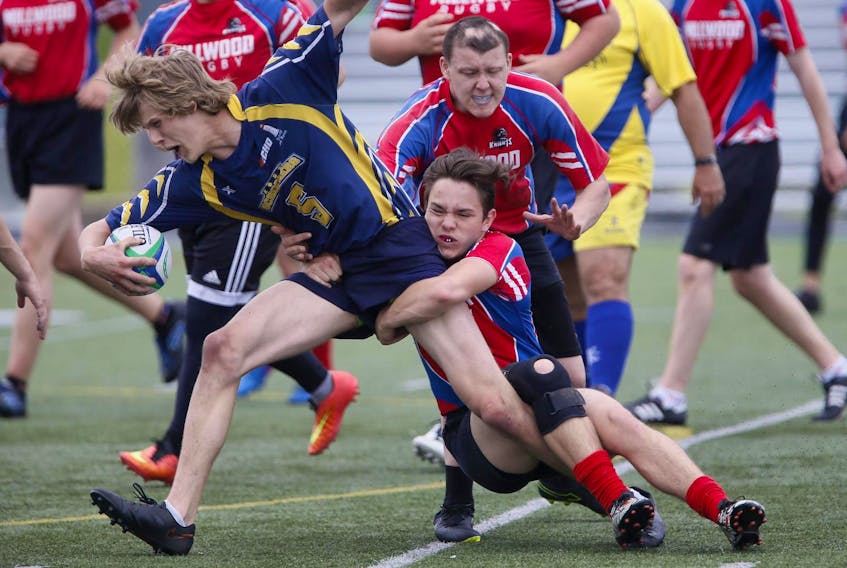 
An Eastern Shore player is tackled by Millwood High’s Corey Northcott during metro high school rugby action at the Burnside Common in May 2018. - Tim Krochak
