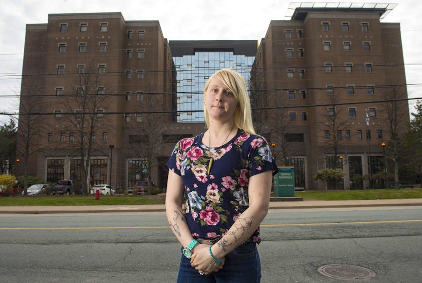 
Sarah Slaunwhite poses for a photo in front of the Halifax Infirmary on Friday afternoon. Slaunwhite used to work at the hospital as a security guard. She says she was expected to guard and subdue criminals as well as take care of people on suicide watch. - Ryan Taplin
