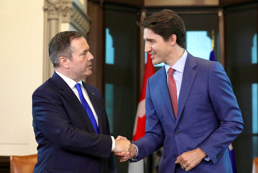 Prime Minister Justin Trudeau shakes hands with Alberta Premier Jason Kenney during a meeting in Trudeau’s office on Parliament Hill on Thursday.