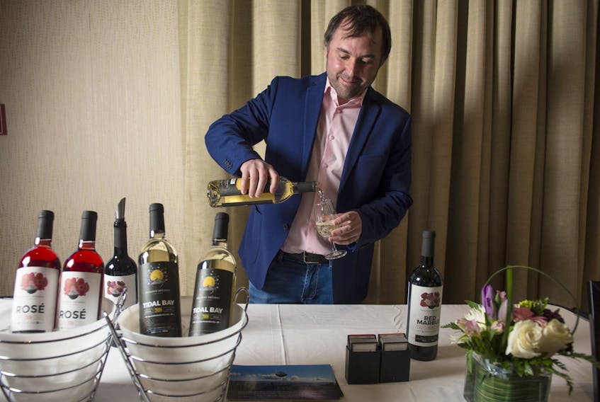 
Ken MacLellan, owner of Eileanan Breagha Vineyards in River Denys, pours a glass of Tidal Bay at the Marriott Harbourfront hotel on Friday. Wineries from around the province were at the Marriott for the annual Tidal Bay release and tasting event. - Ryan Taplin/The Chronicle Herald

