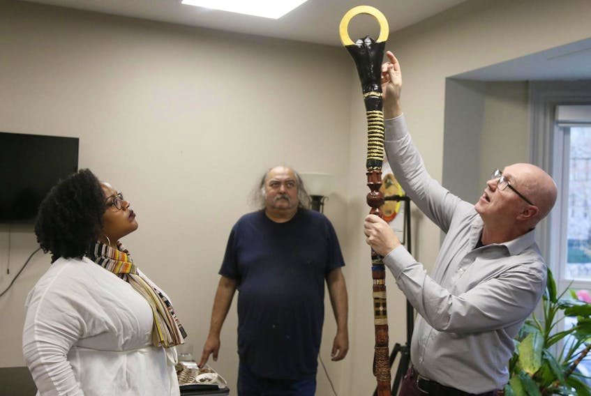 
 Wendie Poitras, left, and Alan Syliboy look on as fellow artist, Mark Austin, points out some of the symbolism on the New Dawn Staff. …… the three are some of the many artists who contributed to the design of the New Dawn Staff, seen at the Indigenous Student Centre at Dalhousie University on Tuesday May 14, 2019. The New Dawn Staff will replace the university’s old convocation staff. - Tim Krochak
