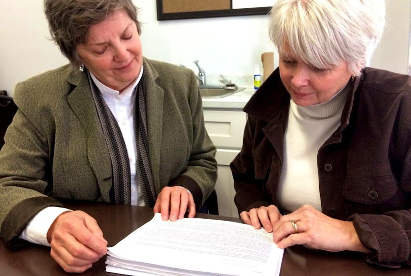 
Joan Skinner, left, and Beth MacKenzie look over one of the emails they sent to Shannex regarding the care their late mother, Pat, received at Northumberland Hall in Amherst. - File

