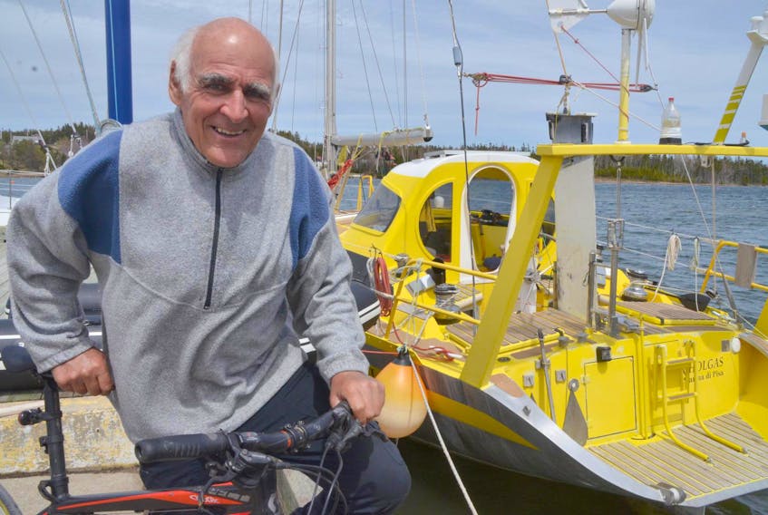 Gil Strohheker with his boat, Cholgas, and bicycle at the at the St Peters Lion's Club Marina.