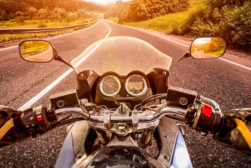 
Biker driving a motorcycle rides along the asphalt road. First-person view. - Andrey Armyagov

