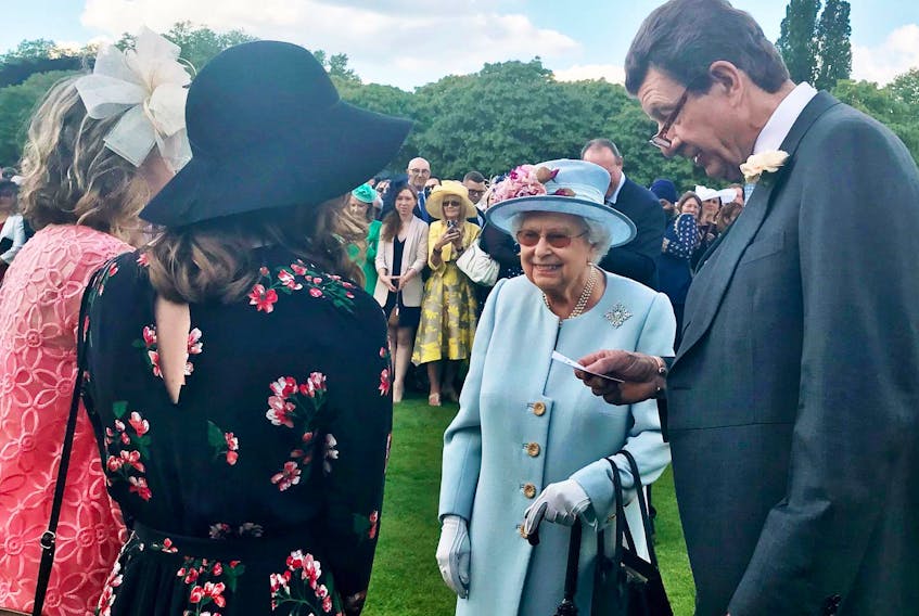 
Maggie and Emma Archibald (left), twin sisters from Bedford, speak with Queen Elizabeth II, at a recent garden party. - Contributed
