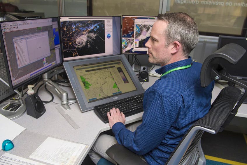 Meteorologist Ian Hubbard pulls up some images on the main work station for the Canadian Hurricane Centre on Thursday.