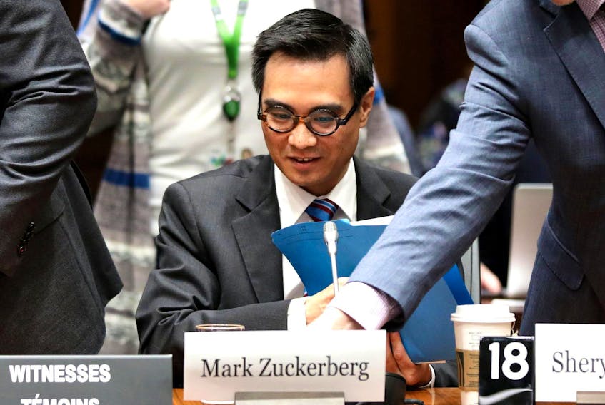 
Kevin Chan, global director and head of public policy of Facebook Canada, looks on as a name plate for Facebook CEO Mark Zuckerberg is placed in front of him after Zuckerberg failed to appear at the International Grand Committee on Big Data, Privacy and Democracy meeting in Ottawa Tuesday. 
