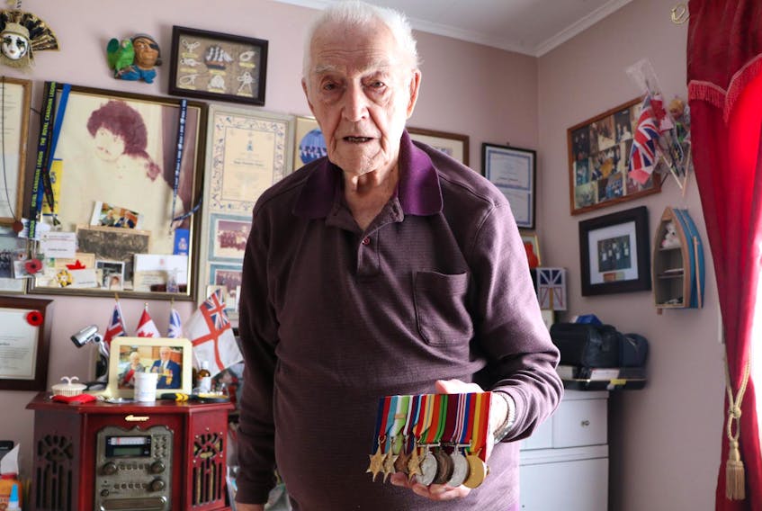 
Charles Starkes, 97, of St. John’s displays his Second World War medals in his reading room. Starkes was a torpedo man on an aircraft carrier that took part in the Allied invasion of occupied France on D-Day, June 6, 1944. He also worked to pull detonators out of mines that had washed ashore on the English coast. - Glenn Whiffen
