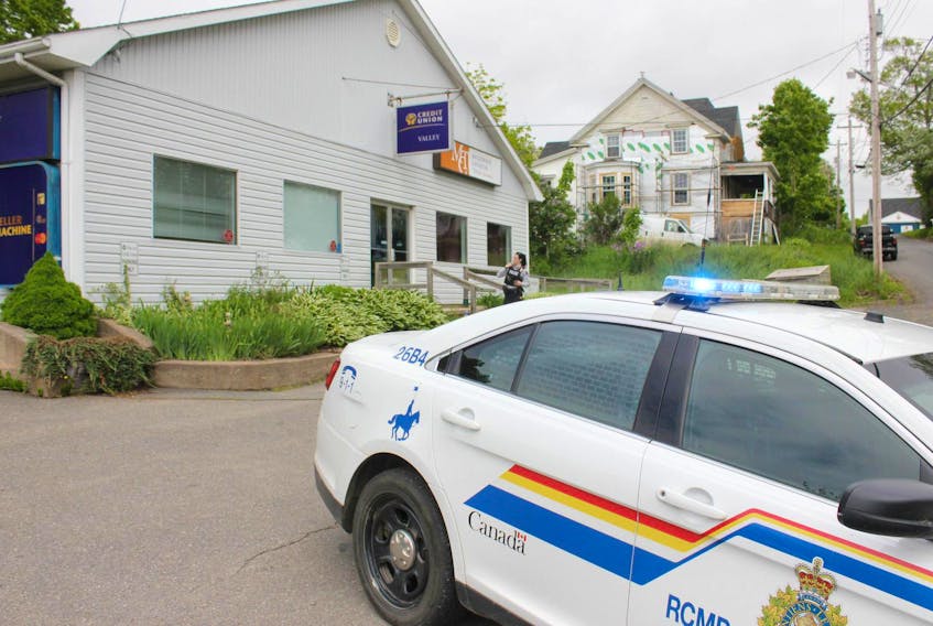 
An RCMP officer stands outside the Valley Credit Union branch in Canning Friday morning, after a shot was fired during an attempted armed robbery. - Ian Fairclough
