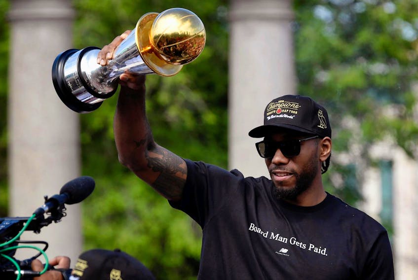 
Toronto Raptors’ Kawhi Leonard holds his MVP trophy during the Raptors NBA championship parade in Toronto on Monday. - Moe Doiron / Reuters
