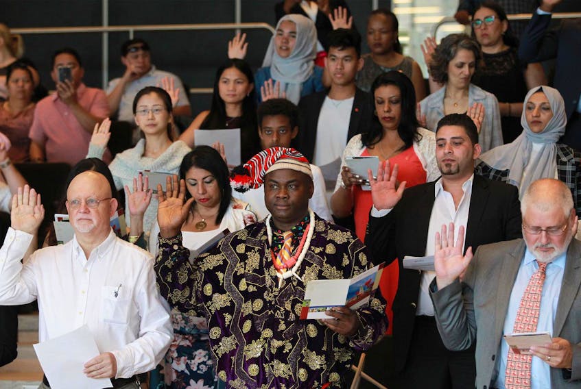 New Canadians are sworn in during an Immigration, Refugees and Citizenship Canada special citizenship ceremony with the Rainbow Refugee Association of Nova Scotia and the Halifax Central Library to celebrate Pride Month. - Tim Krochak