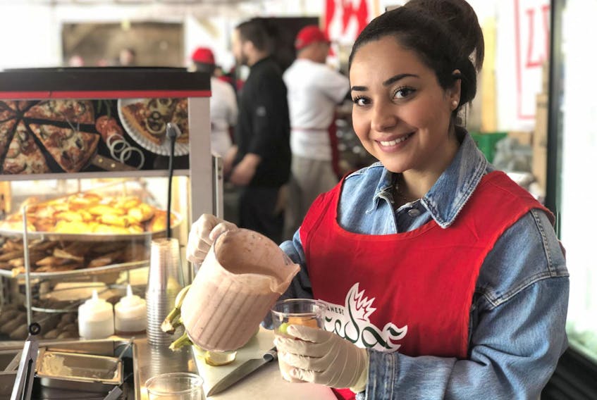 
Joulia Jabbour, shown here serving a Lebanese cocktail to visitors of the Lebanese festival in May. She’s lived in Canada since she was 7 but “My heart is over there.” - Maan Alhmidi
