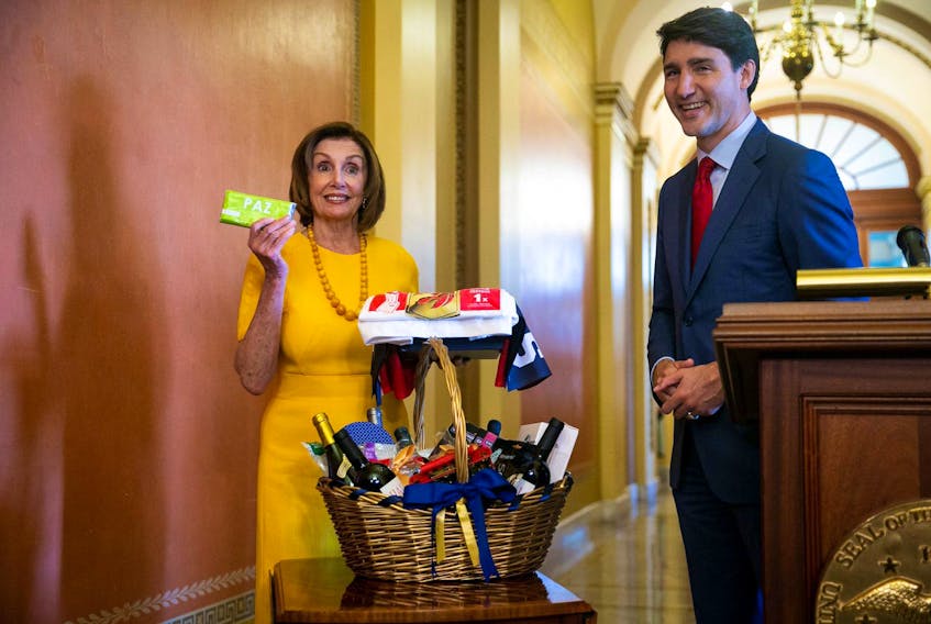 
U.S. House Speaker Nancy Pelosi holds up a Peace by Chocolate bar, one of her gifts from Prime Minister Justin Trudeau, as they settle a wager on the Toronto Raptors defeating the Golden State Warriors in the 2019 NBA Finals, on Capitol Hill in Washington on Thursday, June 20, 2019. - Al Drago / Reuters
