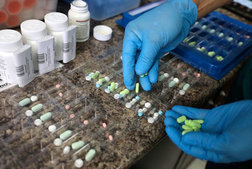 
A pharmacist counts prescription drugs at a pharmacy in Ottawa. - Chris Wattie/Reuters
