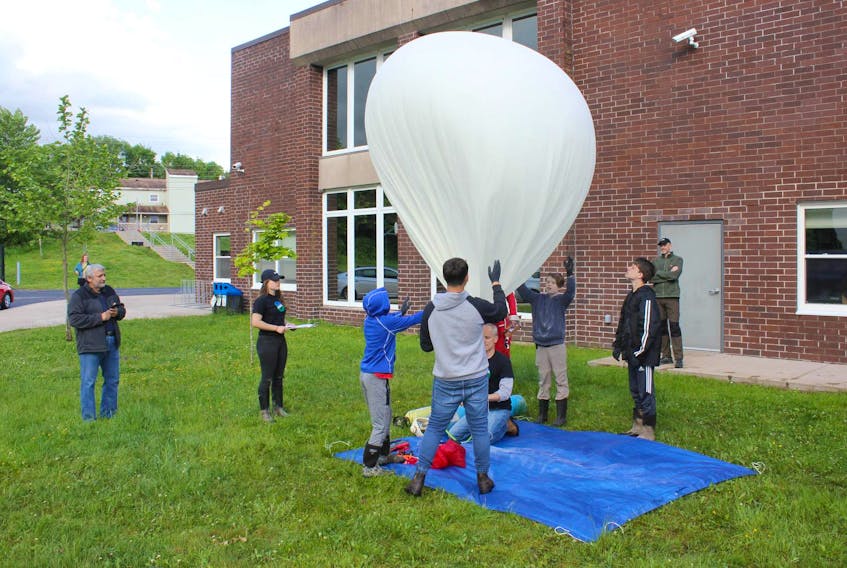 
Students steady the Annapolis Royal Space Agency's balloon as it fills with helium before its launch Saturday. - Ian Fairclough
