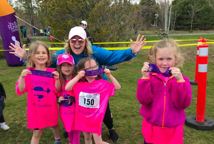 
Lee Anne Webber has fun with her Primary run club students at a youth race. Executive director Kerry Copeland says half of Kids Run Club participants have been girls from the very beginning. 
