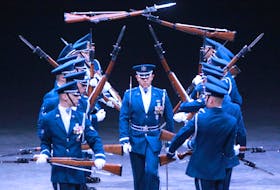 A member of the USAF Honor Guard Drill Team walks between rifles as they’re tossed through the air during a preview for this year’s Royal Nova Scotia International Tattoo. - Tim Krochak