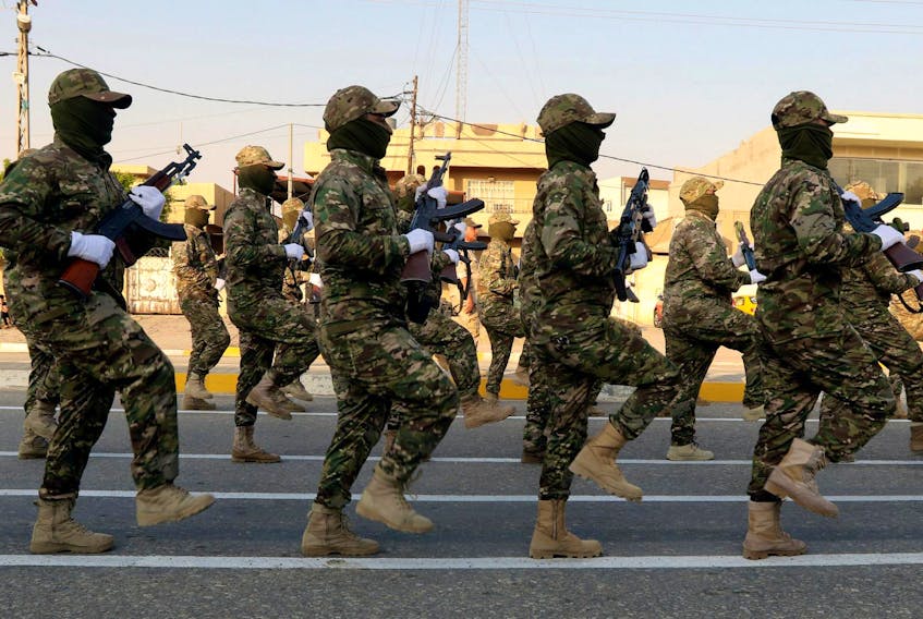 
Members of Iraqi Popular Mobilization Forces (PMF) take part in a military parade in the town of Taza, south of the northern oil city of Kirkuk, Iraq on June 28. No one has defined the size of the security force Iraq needs or how proficient it should be before NATO’s work is considered complete, writes Scott Taylor. - Ako Rasheed/Reuters
