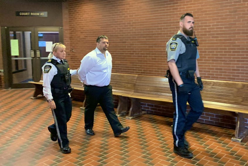 Nikolas Derrick Salsman is led from Kentville Supreme Court Friday after being sentenced to seven and a half years in prison for manslaughter in the 2017 death of a friend.