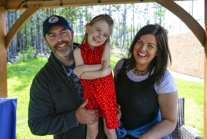 James Hagerty, daughter Lucy, and wife Lara Whatmore, in the backyard of their home in Beaver Bank. After a long wait for a diagnosis for Lucy, she was found to have a rare genetic disorder called KBG syndrome.