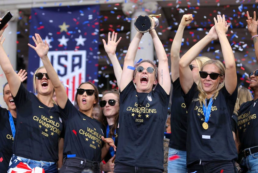 
United States women's national soccer team forward Megan Rapinoe (15) celebrates with the trophy and her teammates at New York City Hall after the ticker-tape parade for the team down the canyon of heroes in New York City. - Brad Penner / USA TODAY Sports
