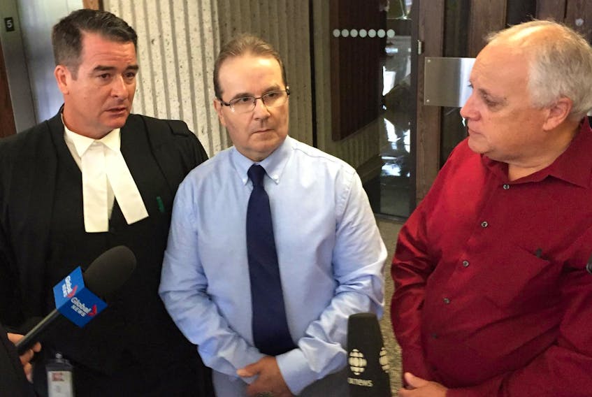 
Glen Assoun, centre, his lawyer Sean MacDonald, left, and Ron Dalton, co-founder of Innocence Canada, discuss the release of hundreds of documents in Assoun’s wrongful murder conviction case Friday outside Nova Scotia Supreme Court in Halifax. - File
