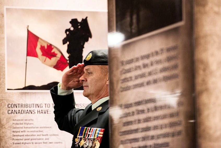 
A Canadian soldier salutes during a memorial vigil in Halifax on Oct. 15, 2014. The Kandahar Airfield Centotaph was travelling across Canada before being permanently installed in Ottawa. - Christian Laforce / File
