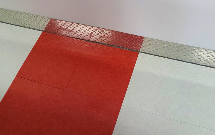 
The finishing touches on Claude’s garage project featured a red and white checker-board floor.
