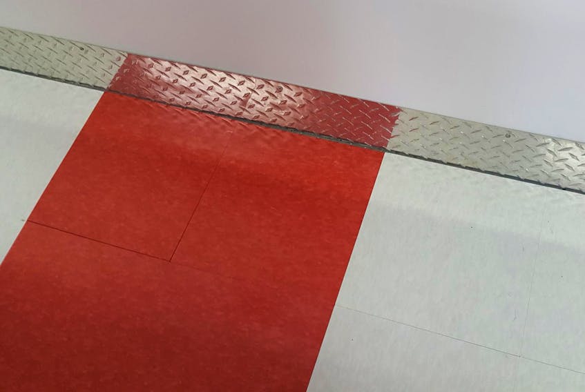 
The finishing touches on Claude’s garage project featured a red and white checker-board floor.

