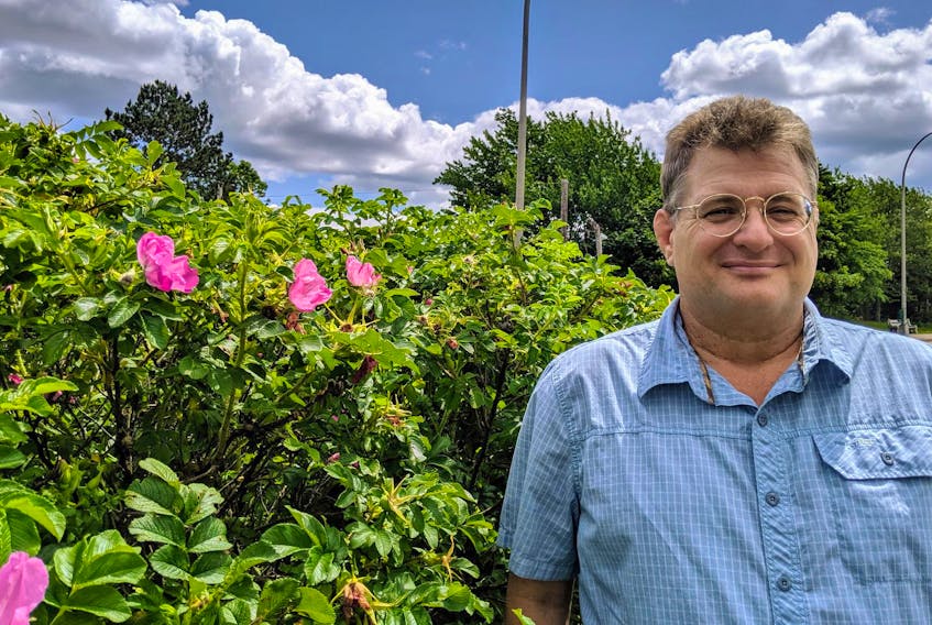 
Mark Lummis of Halifax beside a rose-filled median on Dunbrack Street. Lummis has started a petition to stop Halifax Regional Municipality from cutting down the rose bushes. - John McPhee
